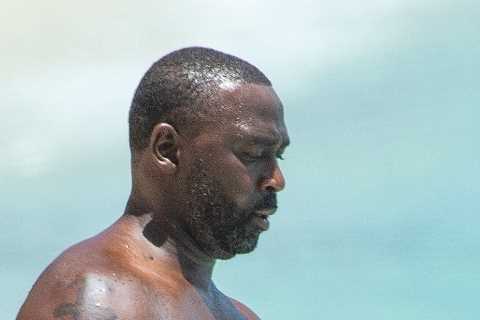 Man Utd legend Andy Cole takes dip in the sea as he relaxes on family holiday in Barbados