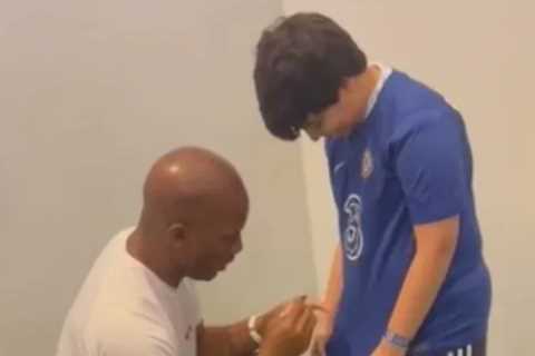Watch hilarious moment young fan gets Chelsea shirt signed by Didier Drogba before whipping it off to reveal Arsenal top