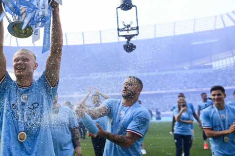 Erling Haaland drenched in champagne by Man City team-mates as record goal-scorer hoists Premier League trophy aloft