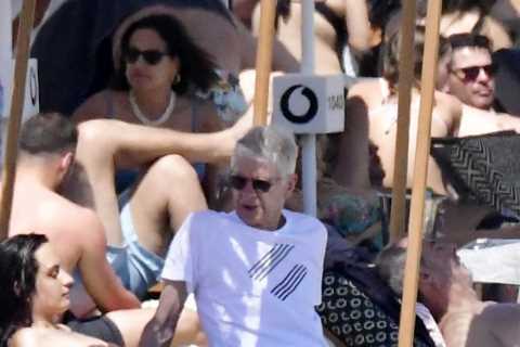 Legendary Arsenal boss Arsene Wenger, 73, relaxes on beach alongside bikini-clad beauties in Mykonos